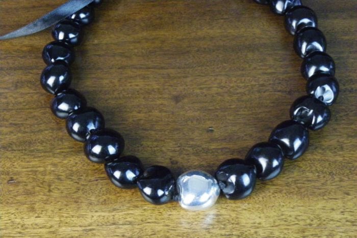 25 inch Black Kukui Nut Lei with 99% Pure Silver Plated Center Kukui