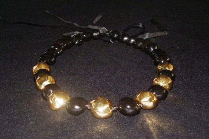 35 inches long Polished Black Kui Nut Lei with 24K Gold Center Kukui surrounded with Ten 99% Pure Fine Silver Kukui Nuts