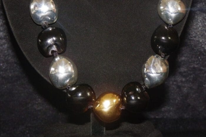 35 inches long Polished Black Kui Nut Lei with 24K Gold Center Kukui surrounded with Ten 99% Pure Fine Silver Kukui Nuts