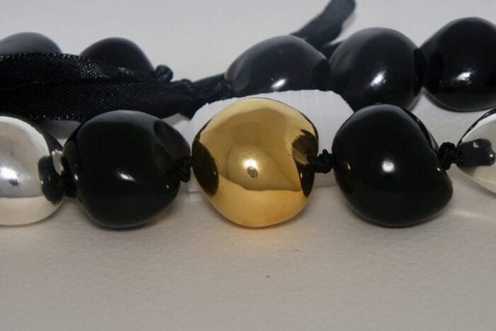 35 inches long Polished Black Kui Nut Lei with 24K Gold Center Kukui surrounded with Ten 99% Pure Fine Silver Kukui Nuts