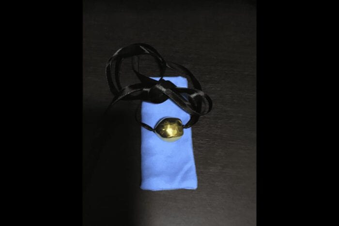 Single 24K Gold Plated Kukui Nut on a Black Satin Ribbon