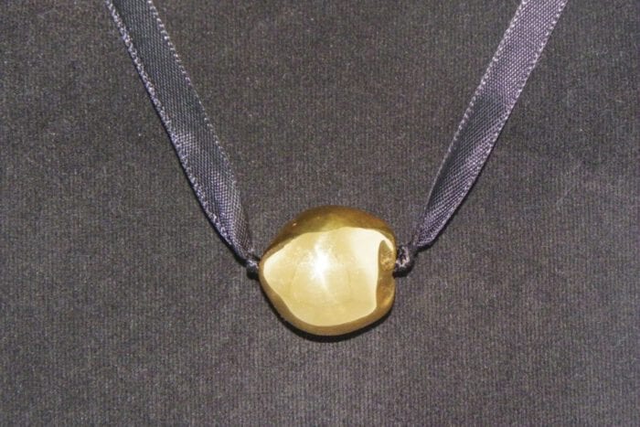 Single 24K Gold Plated Kukui Nut on a Black Satin Ribbon